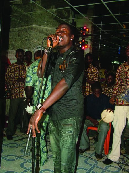 Taiye Currency performing on stage